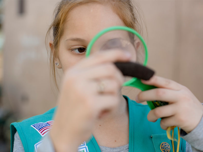 Girl Scout Using Magnifying Glass