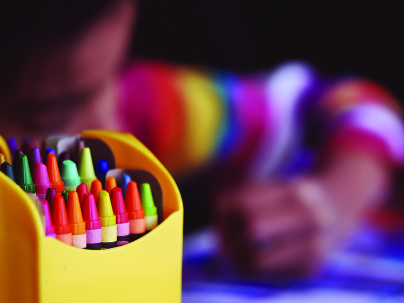 Child Coloring with Crayons